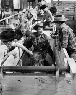 Gig Young (center on horse), on-set of the western film, "Arena", Loew's Inc., 1953