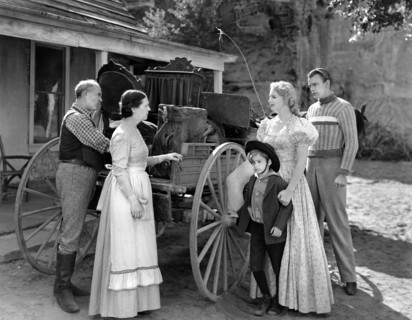 Scotty Beckett (small boy), Virginia Bruce (2nd right), Dennis O'Keefe (right), on-set of the