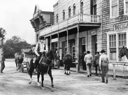 Rory Calhoun (on horse), on-set of the western film, "Domino Kid", Columbia Pictures, 1957