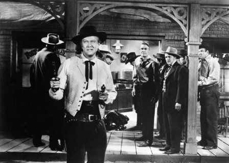 David Brian (foreground), Randolph Scott (background center), on-set of the western film, "Fort