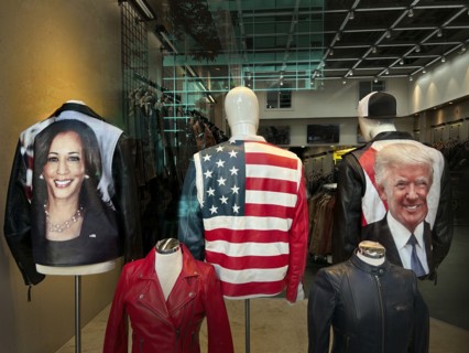 Clothing store window featuring images of Kamala Harris and Donald Trump on the backs of jackets,