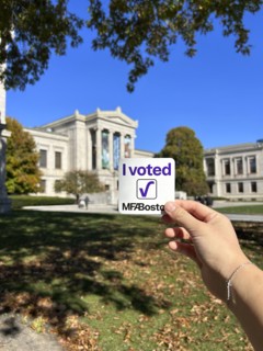 Hand holding "I Voted MFA Boston" sticker, Museum of Fine Arts, Boston, Massachusetts, USA