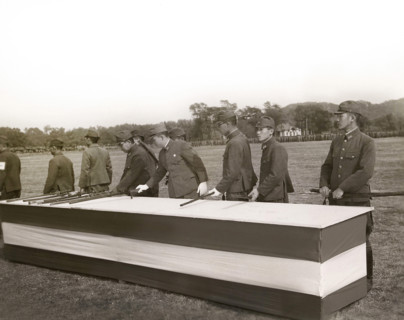 Japanese surrender party placing swords on table in final act of surrender in the presence (not