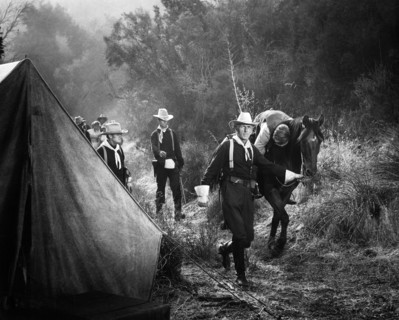 Roy Gordon (walking with horse), Richard Denning (injured on horse), on-set of the western film,
