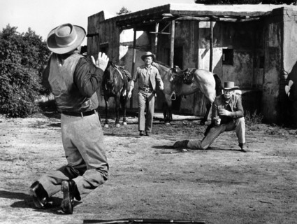 Jay C. Flippens (rear view,, on knees), Bill Williams (center), Ward Bond (right), on-set of the