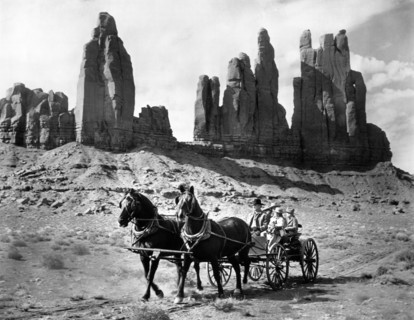 George Peppard, Carolyn Jones (holding young girl on lap), on-set of the western film, "How The