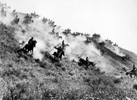 Native American fighters charging down hillside on horseback, on-set of the western  film, "Little