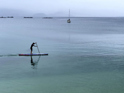 Man paddle boarding on calm water, Bueu, Pontevedra, Galicia, Spain
