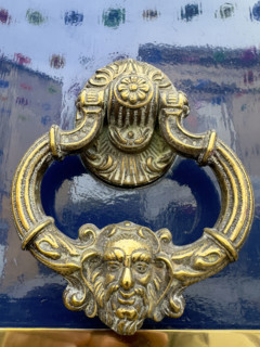 Brass door knocker on blue lacquer door