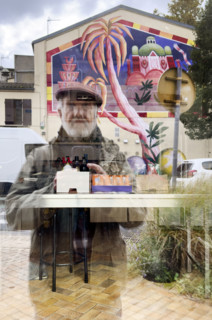 Reflection of mature adult man taking a selfie in store window