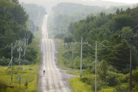 Lone biker on country road