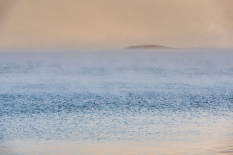 Fog on lake at sunrise
