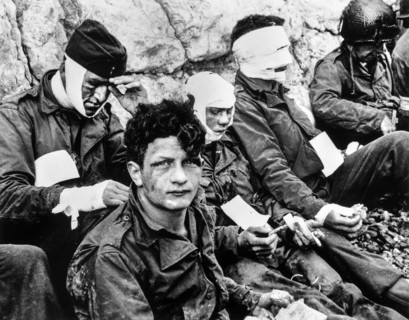 American Assault Troops of the 16th Infantry Regiment, Injured while storming Omaha Beach, wait by