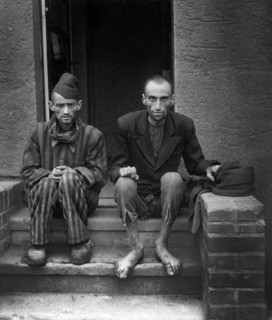 Two staring, emaciated men after being liberated from Mittelbau-Dora, a Gestapo concentration camp,