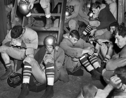 Gloomy high school football team in locker room during halftime, Freeport, New York, USA, Walter