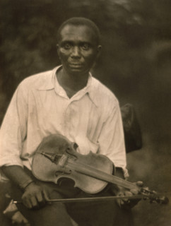 Seated portrait of man holding violin, Doris Ulmann, 1930