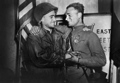 U.S. 2nd Lieutenant William Robertson and Lt. Alexander Sylvashko, Russian Army, in front of sign