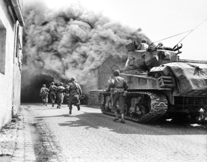 U.S. soldiers of 55th Armored Infantry Battalion and tank of the 22nd Tank Battalion, moving