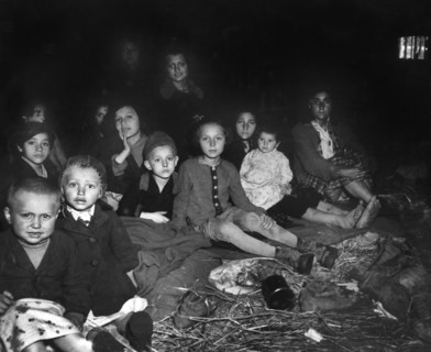 Group of liberated women and children after concentration camp for Jewish prisoners was overrun by