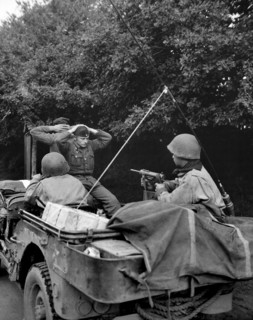 Two German prisoners of war being taken to U.S. 6th Division Prisoner of War Encampment for