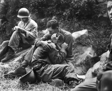 Grief stricken American infantryman whose buddy had been killed in action being comforted by