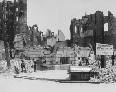 Damaged buildings after earthquake with sign for Sullivan Contracting Company, possibly at Bush and