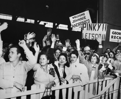 families of returning Prisoners of War waving and greeting USNS General Nelson M. Walker as it