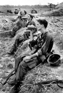 Members of U.S.25th Infantry Division drinking from their canteens during break in patrol