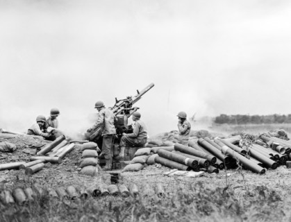 American gun battery of an anti-aircraft unit going into action on Omaha Beachhead, near Vierville