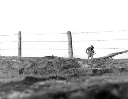 U.S. infantryman of 82nd Airborne Division, going on one-man sortie, covered by buddy in