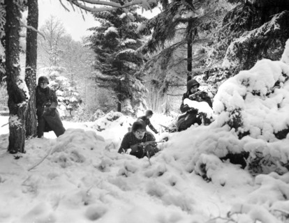 American infantrymen of the 29th Regiment., 75th Infantry Division fighting in fresh snowfall near