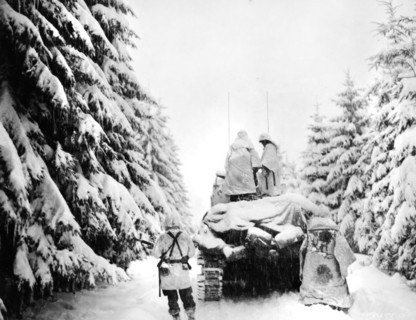 U.S. tank and Infantrymen of the 82nd Airborne Division pushing through snow, near Herresbach,