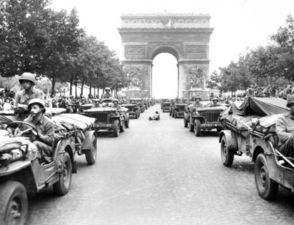 Military jeeps of American 28th Infantry Division moving down Champs Elysees, passing through Arc
