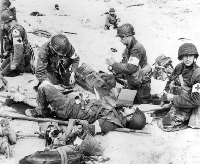 American medics rendering first aid to troops in initial landing on Utah Beach, Les Dunes de
