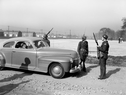 Home guard troops with bared bayonets preventing cars from entering Sojourner Truth Homes, a U.S.