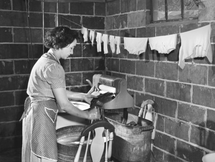 Woman wringing out washed clothes, Point Pleasant, West Virginia, USA, Arthur S. Siegel, U.S.