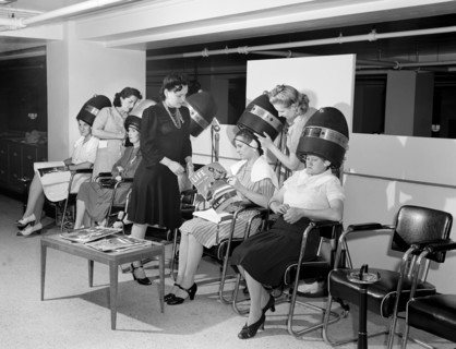 Women drying their hair in beauty shop at Crowley-Milner department store, Detroit, Michigan, USA,