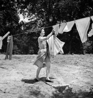 Woman removing laundry from clothes line, Point Pleasant, West Virginia, USA, Arthur S. Siegel, U.S
