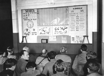 Officers and enlisted men of 2nd Infantry Division, 1st U.S. Army watching board giving them