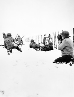 Reconnaissance squadron advancing cautiously through snow with rifle grenades, attacking German