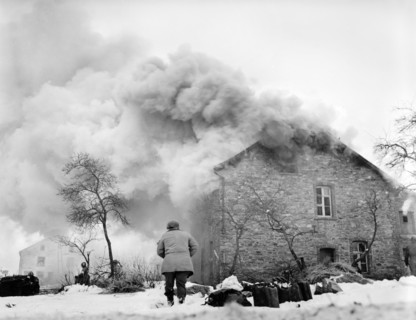 Burning home drew heavy barrage of enemy shellfire, near Lmore, Belgium, U.S. Army Signal Corps,