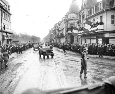 French crowd greeting convoys of U.S. 28th Infantry Division going through city after its