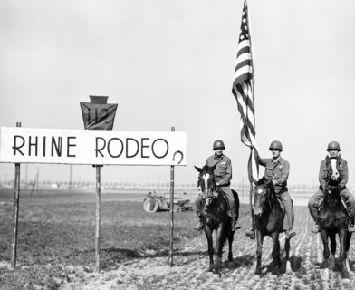 Infantrymen of the 28th Division, U.S. First Army, stage a rodeo on bank of Rhine River while