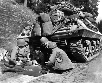 American tank destroyer crew, U.S. Third Army, 28th Division, shooting craps while awaiting removal