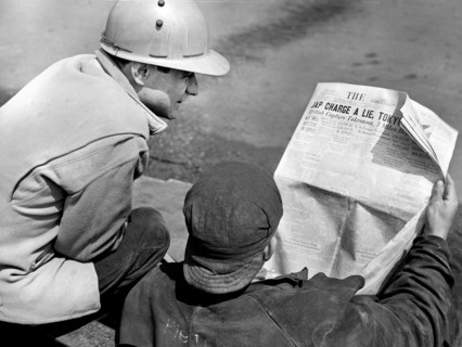 Two factory workers reading the Baltimore Sun newspaper during lunch time, Bethlehem-Fairfield
