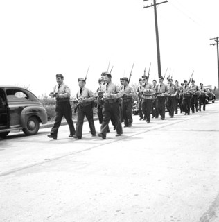 Home guard troops, with bared bayonets, carrying mess kits at Sojourner Truth Homes, a U.S. Federal