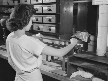 Female manufacturing chemist making wax capsules used for silver nitrate solution, Parke, Davis and