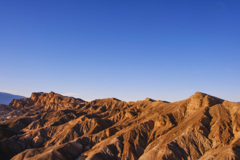 Hikers in distance along crest of Red Cathedral Trail near Zabriskie Point, Death Valley National