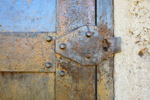 Close-up detail of rusted metal jail door