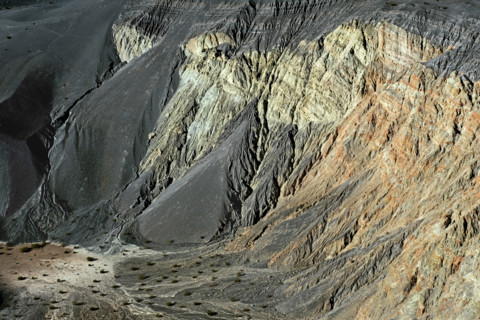 Large amounts of volcanic cinder deposits in basin and gullies on south facing wall of Ubehebe